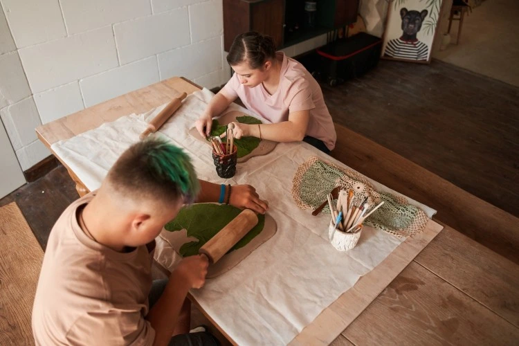Two disabled friends in art class together
